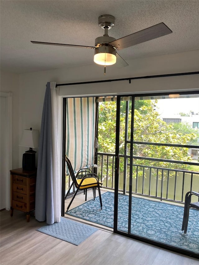 7951 58th Ave N Unit 308, Saint Petersburg, FL 33709 - sitting room with a textured ceiling, wood finished floors, and ceiling fan