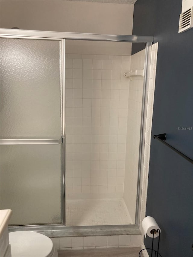 7951 58th Ave N Unit 308, Saint Petersburg, FL 33709 - full bathroom featuring a stall shower and toilet