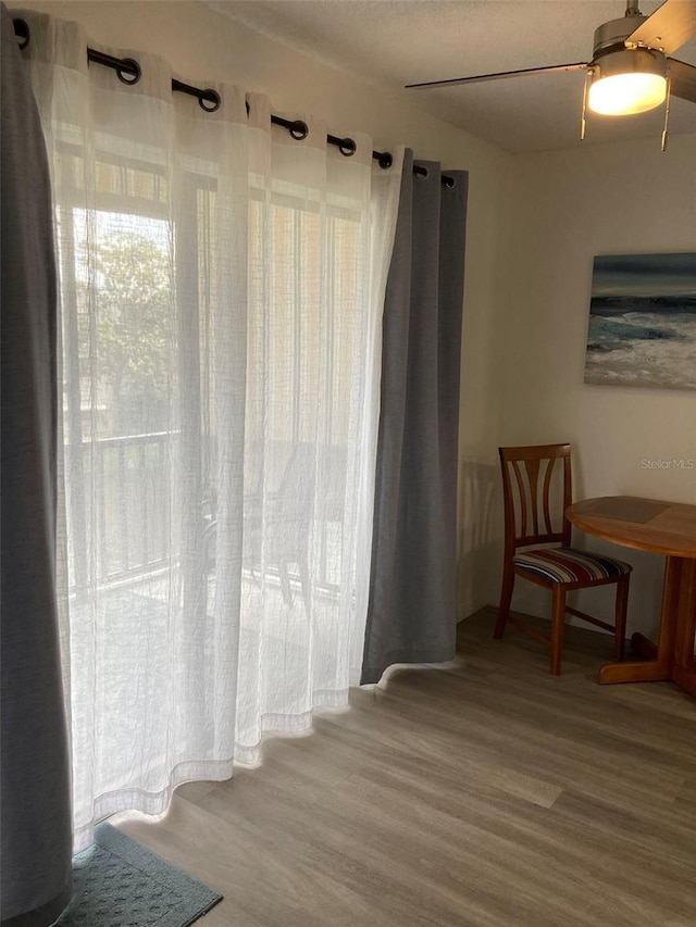 7951 58th Ave N Unit 308, Saint Petersburg, FL 33709 - sitting room with wood finished floors and a ceiling fan