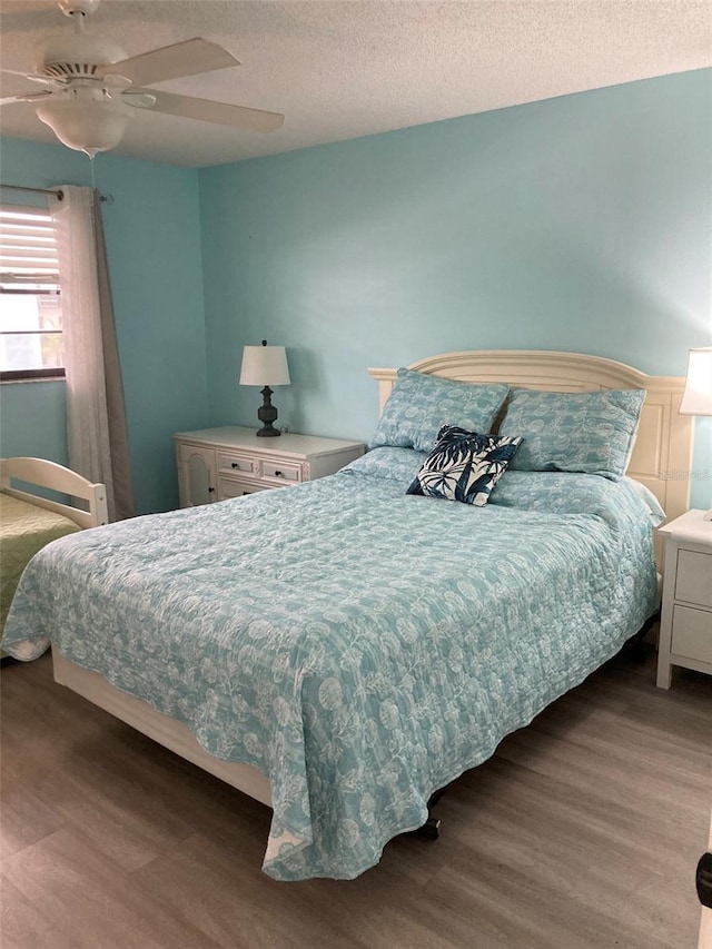 7951 58th Ave N Unit 308, Saint Petersburg, FL 33709 - bedroom with wood finished floors, a textured ceiling, and ceiling fan