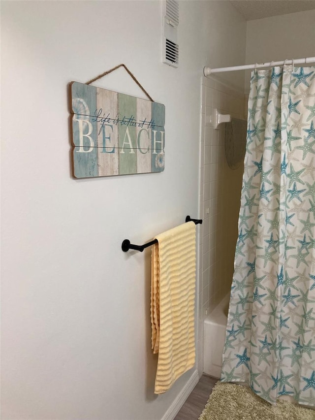 7951 58th Ave N Unit 308, Saint Petersburg, FL 33709 - bathroom with shower / tub combo and wood finished floors