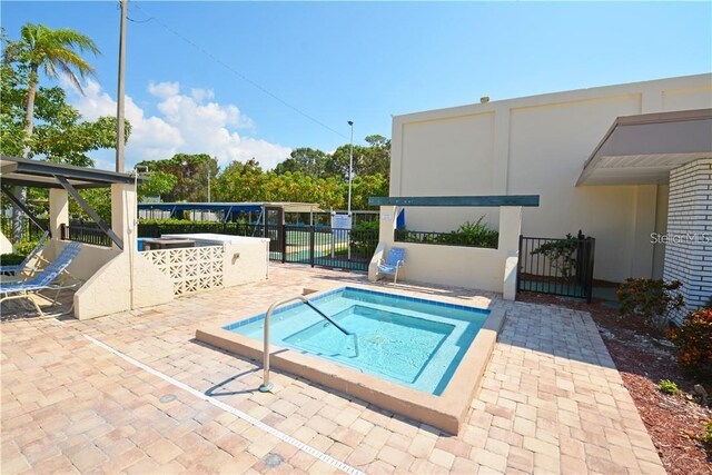 7951 58th Ave N Unit 308, Saint Petersburg, FL 33709 - view of pool with a hot tub, fence, and a patio