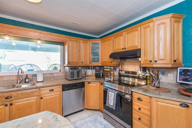 kitchen with appliances with stainless steel finishes, light stone counters, a sink, backsplash, and under cabinet range hood