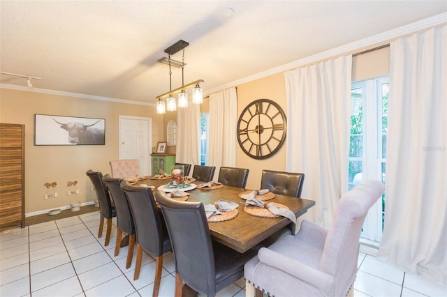 dining area featuring plenty of natural light, ornamental molding, baseboards, and light tile patterned floors