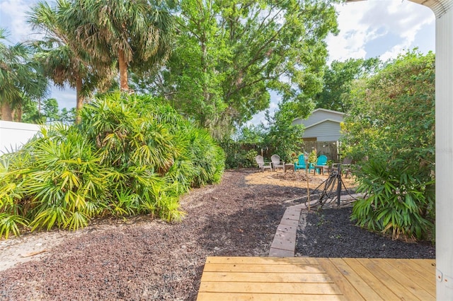 view of yard featuring a deck and fence