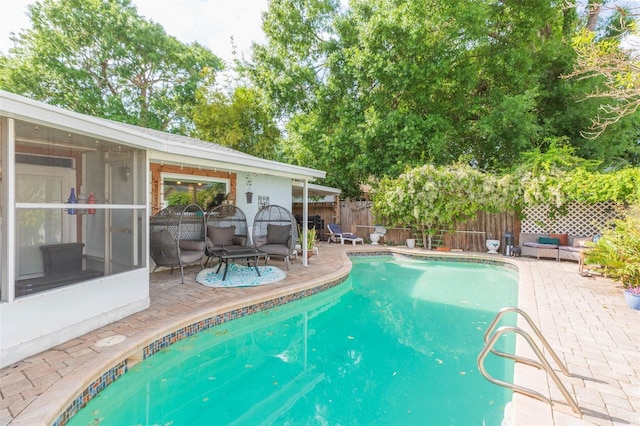 view of swimming pool with a fenced backyard, a fenced in pool, and a patio
