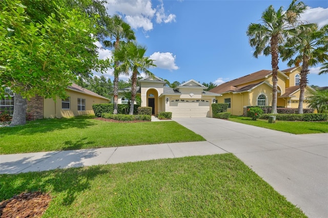 3315 Granite Ridge Loop, Land O Lakes, FL 34638 - mediterranean / spanish house with a front lawn, driveway, stucco siding, and an attached garage