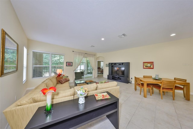 3315 Granite Ridge Loop, Land O Lakes, FL 34638 - living room featuring light tile patterned floors, visible vents, baseboards, arched walkways, and recessed lighting
