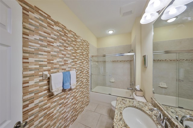 3315 Granite Ridge Loop, Land O Lakes, FL 34638 - bathroom with tile patterned flooring, toilet, bath / shower combo with glass door, and vanity