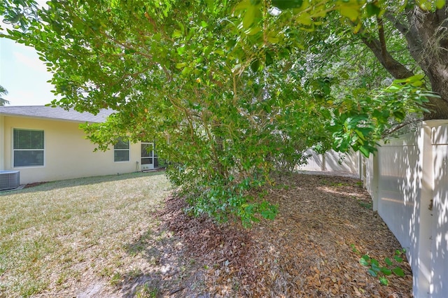 3315 Granite Ridge Loop, Land O Lakes, FL 34638 - view of yard featuring central AC unit and a fenced backyard