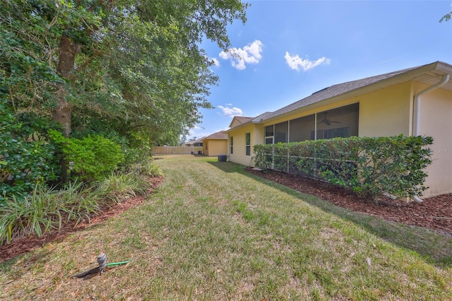 3315 Granite Ridge Loop, Land O Lakes, FL 34638 - view of yard featuring a sunroom, fence, and a ceiling fan