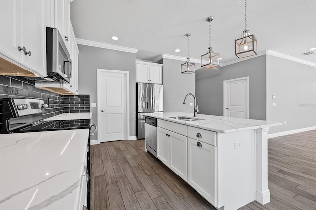 kitchen featuring decorative backsplash, recessed lighting, white cabinets, a sink, and stainless steel appliances