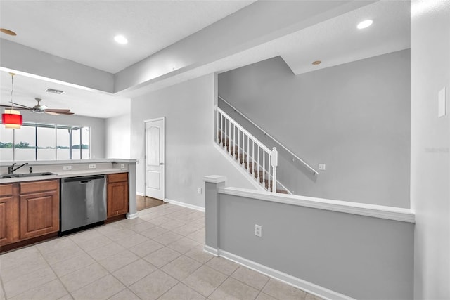 4862 Pond Ridge Dr, Riverview, FL 33578 - kitchen with dishwasher, a sink, ceiling fan, brown cabinetry, and light tile patterned flooring