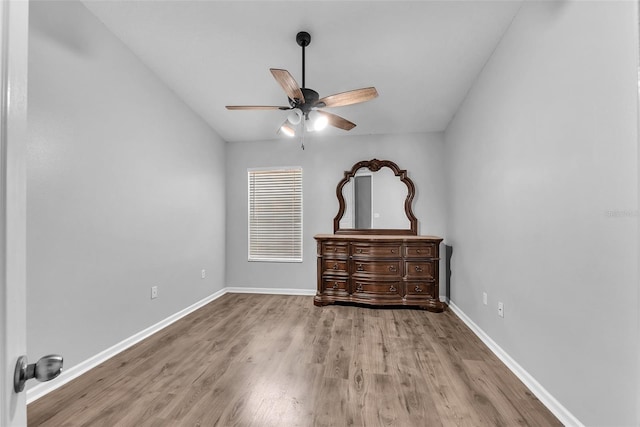 4862 Pond Ridge Dr, Riverview, FL 33578 - unfurnished bedroom with wood finished floors, baseboards, and ceiling fan