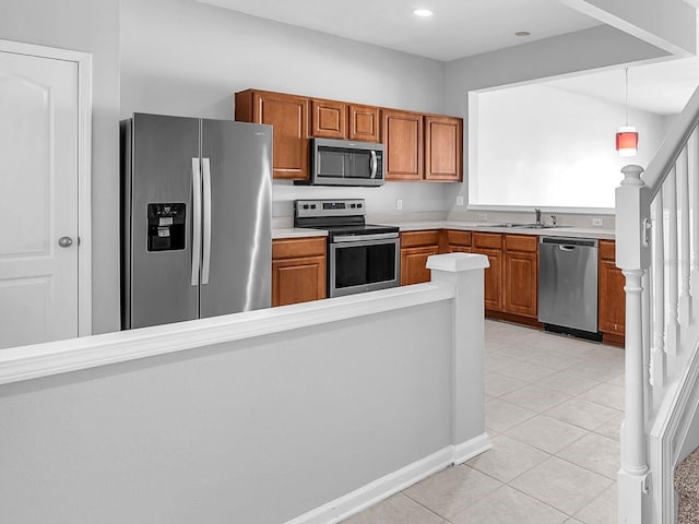 4862 Pond Ridge Dr, Riverview, FL 33578 - kitchen featuring appliances with stainless steel finishes, brown cabinets, light countertops, a sink, and recessed lighting