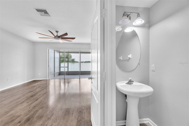 4862 Pond Ridge Dr, Riverview, FL 33578 - bathroom featuring a ceiling fan, wood finished floors, baseboards, and a sink