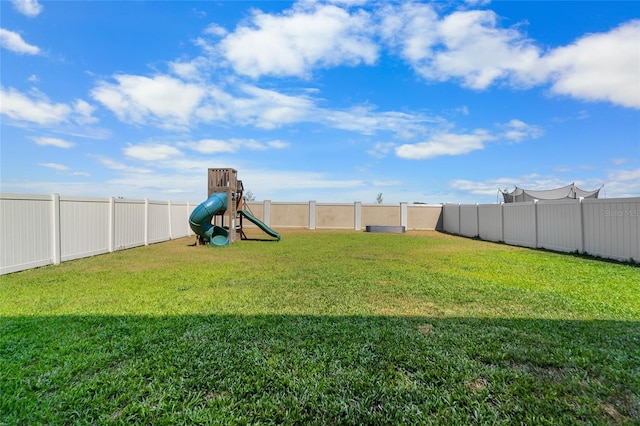 view of yard featuring a playground and a fenced backyard