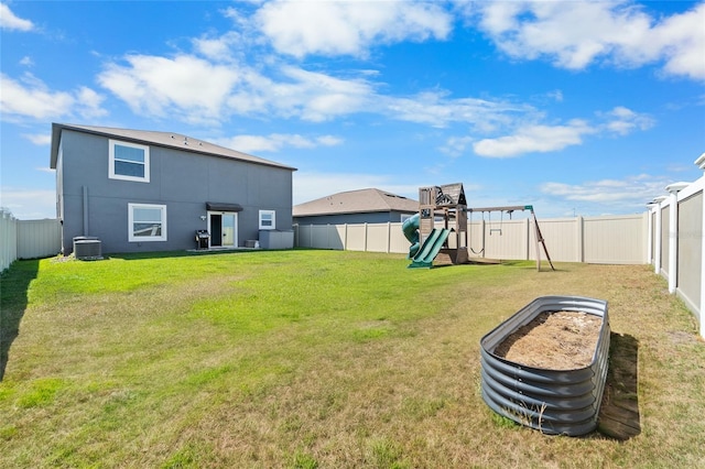 view of yard with a fenced backyard, central air condition unit, and a playground
