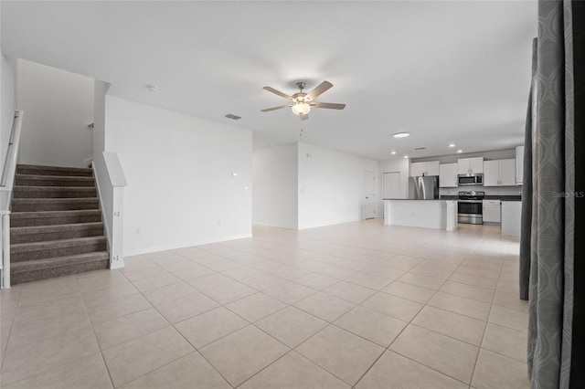 unfurnished living room featuring recessed lighting, ceiling fan, light tile patterned flooring, and stairway