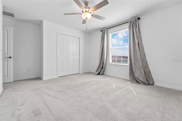 unfurnished bedroom with baseboards, visible vents, a closet, and carpet flooring