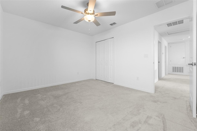 unfurnished bedroom with visible vents and light colored carpet