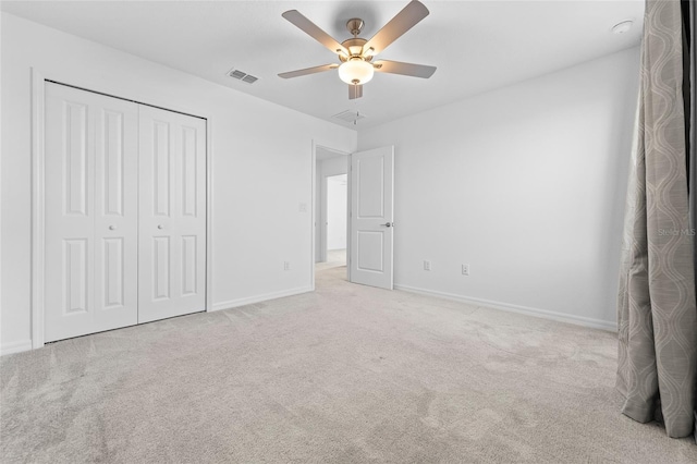 unfurnished bedroom featuring visible vents, carpet, and baseboards