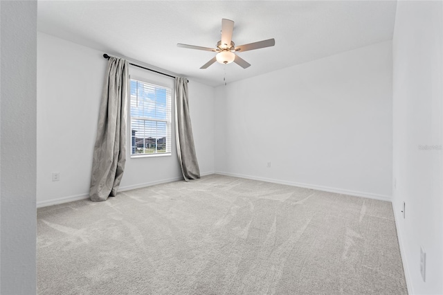 spare room featuring ceiling fan, baseboards, and carpet floors
