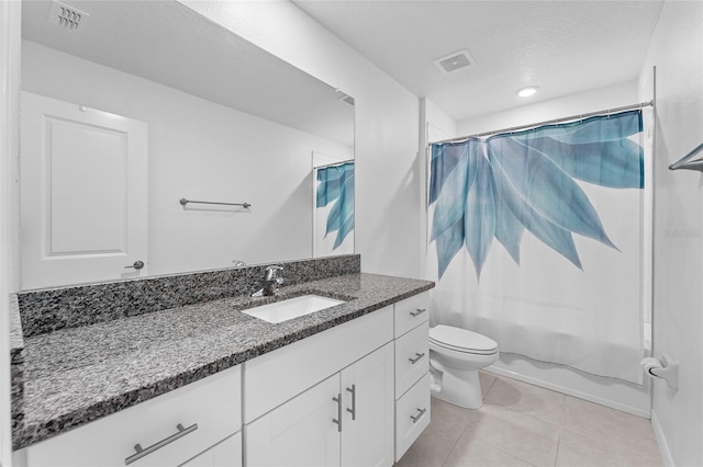 bathroom with toilet, visible vents, vanity, and tile patterned flooring