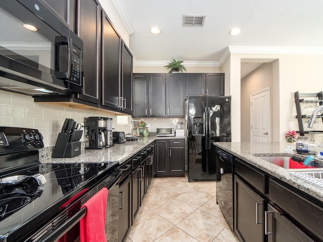 311 Vista Cruiser Ln, Oldsmar, FL 34677 - kitchen with black appliances, light stone countertops, a sink, tasteful backsplash, and crown molding