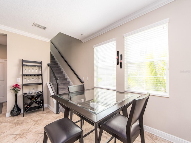 311 Vista Cruiser Ln, Oldsmar, FL 34677 - dining space with stairs, ornamental molding, healthy amount of natural light, baseboards, and light tile patterned floors