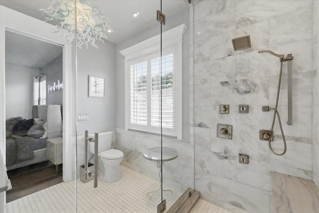 3111 W De Leon St Unit 8, Tampa, FL 33609 - bathroom with a stall shower, plenty of natural light, toilet, a chandelier, and tile walls