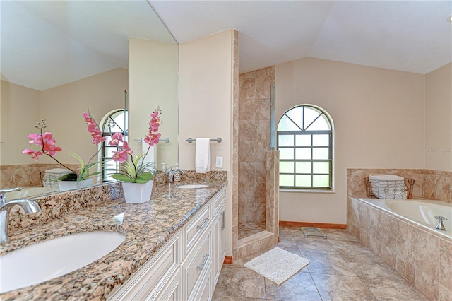 full bath featuring a garden tub, a sink, vaulted ceiling, and tiled shower