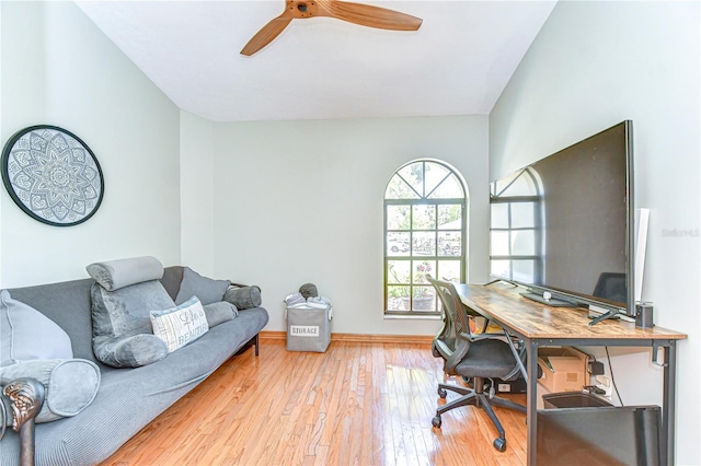 office area with wood-type flooring, ceiling fan, and baseboards