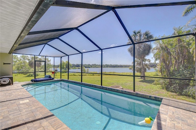 pool with a lawn, a water view, a patio area, and a lanai
