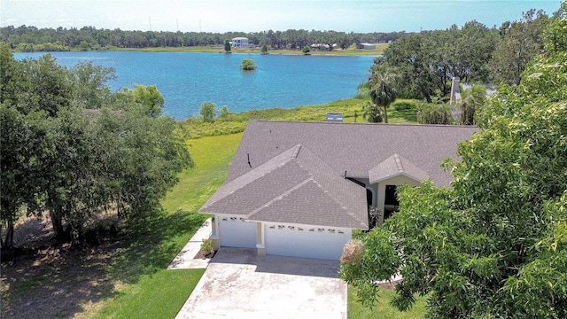 birds eye view of property with a water view