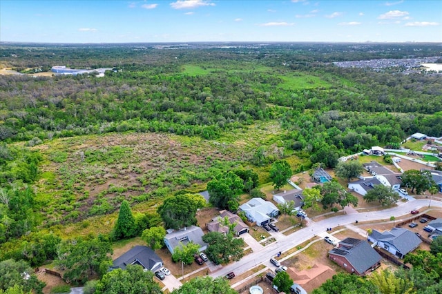 birds eye view of property featuring a residential view and a forest view