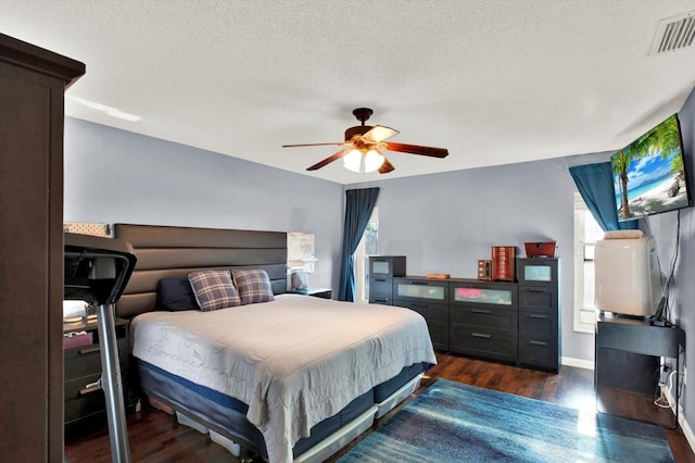bedroom featuring visible vents, wood finished floors, and multiple windows