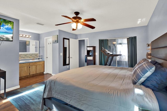 bedroom featuring a ceiling fan, visible vents, baseboards, ensuite bathroom, and dark wood-type flooring
