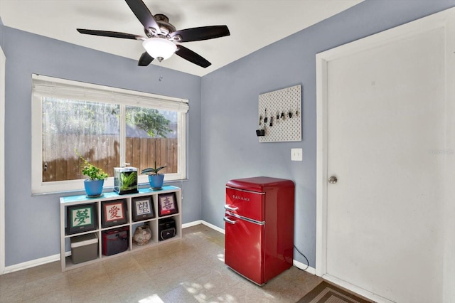 recreation room with baseboards and a ceiling fan