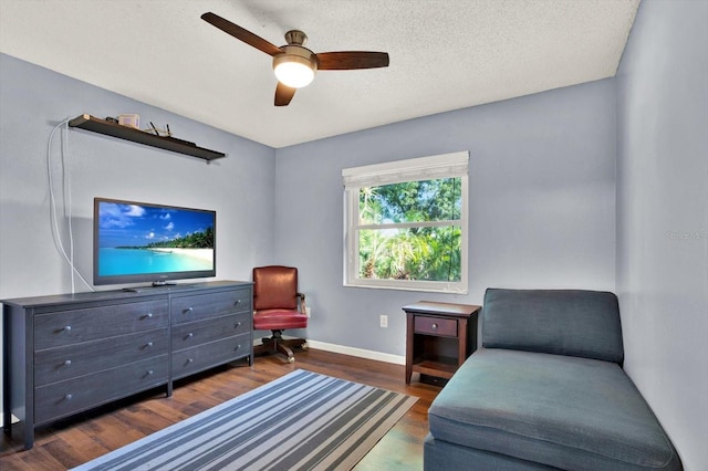 sitting room featuring a ceiling fan, baseboards, and wood finished floors