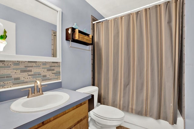 full bathroom featuring vanity, backsplash, toilet, and shower / bath combo with shower curtain