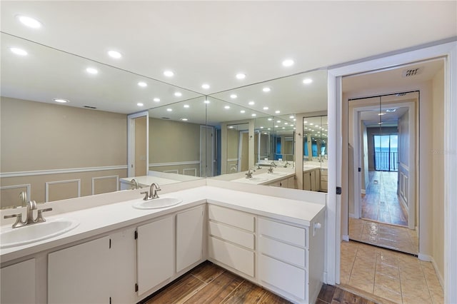 433 Mariner Dr Unit 433, Tarpon Springs, FL 34689 - bathroom featuring double vanity, a sink, and wood finished floors