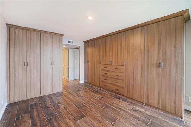 433 Mariner Dr Unit 433, Tarpon Springs, FL 34689 - unfurnished bedroom featuring dark wood-style flooring, baseboards, and visible vents