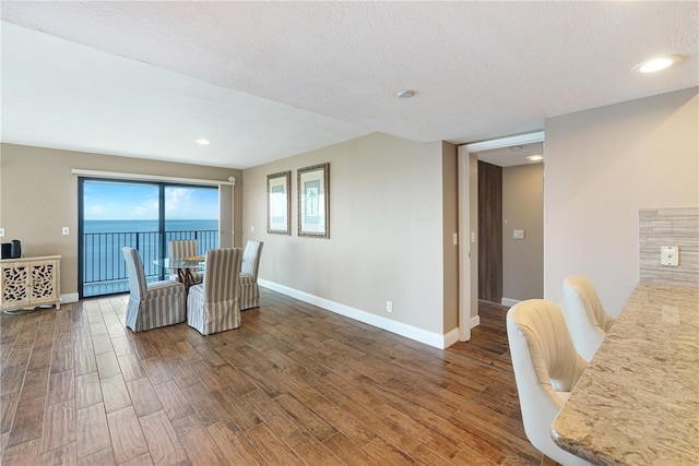 433 Mariner Dr Unit 433, Tarpon Springs, FL 34689 - dining space with baseboards, recessed lighting, a textured ceiling, and wood finished floors