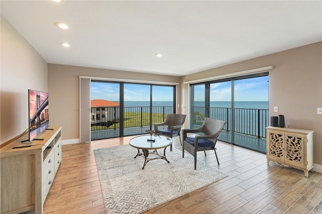 433 Mariner Dr Unit 433, Tarpon Springs, FL 34689 - living room with baseboards, a water view, recessed lighting, and light wood-style flooring