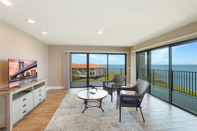 433 Mariner Dr Unit 433, Tarpon Springs, FL 34689 - living room featuring a water view, baseboards, recessed lighting, and light wood-type flooring