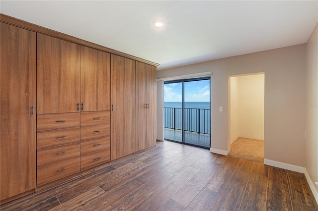 433 Mariner Dr Unit 433, Tarpon Springs, FL 34689 - unfurnished bedroom featuring baseboards, recessed lighting, dark wood-style floors, and access to exterior