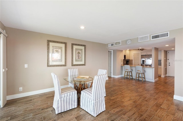 433 Mariner Dr Unit 433, Tarpon Springs, FL 34689 - dining room with baseboards, visible vents, and wood finished floors