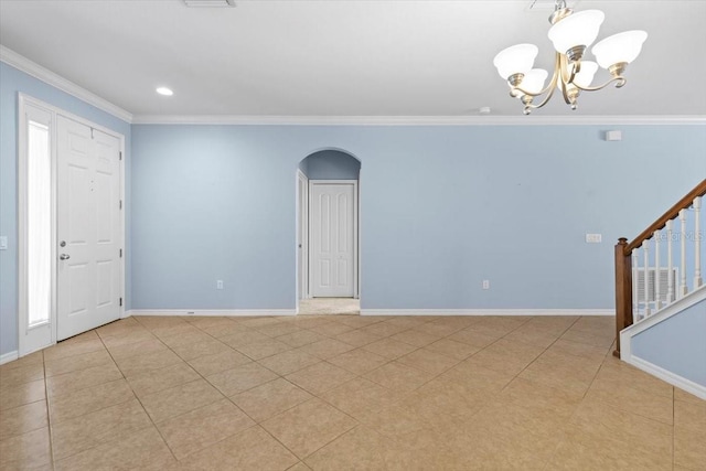 entryway with stairway, a chandelier, crown molding, arched walkways, and baseboards
