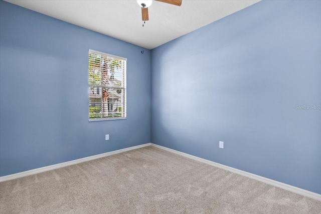 unfurnished room featuring carpet flooring, baseboards, and ceiling fan